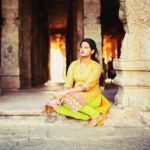 Young adult reflecting peacefully inside an Indian temple, exploring spirituality, mindfulness, and mental wellness in the digital age.